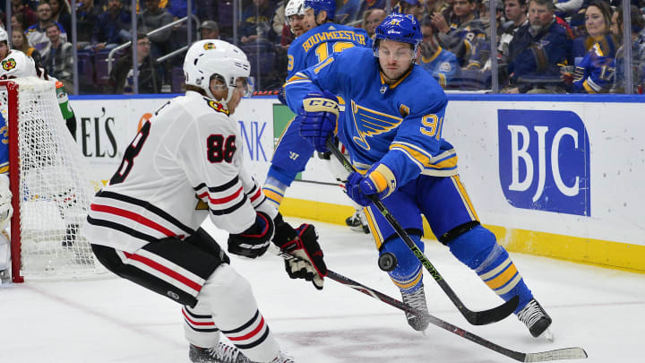 Oct 27, 2018; St. Louis, MO, USA; St. Louis Blues right wing Vladimir Tarasenko (91) clears the puck past Chicago Blackhawks right wing Patrick Kane (88) during the first period at Enterprise Center. Mandatory Credit: Jeff Curry-USA TODAY Sports