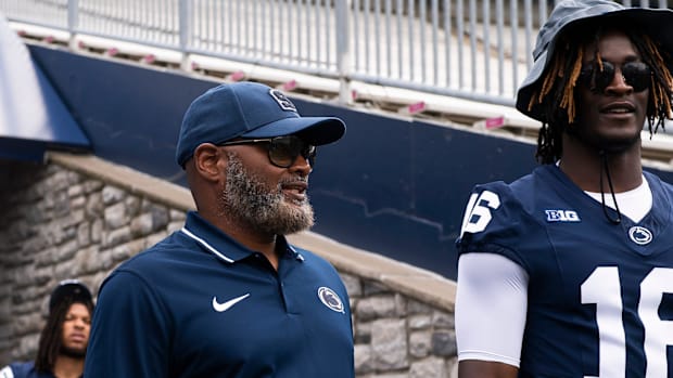 Penn State assistant head coach Terry Smith talks with cornerback Elliot Washington II (16) at Beaver Stadium.