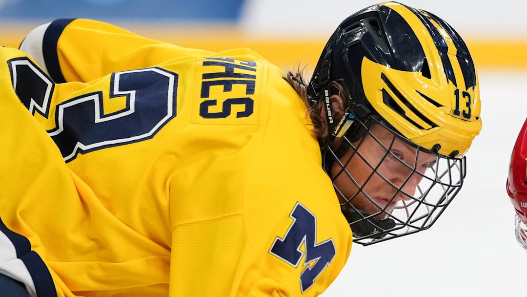 Apr 9, 2026; Las Vegas, Nevada, UNITED STATES; Michigan Wolverines forward T. J. Hughes (13) prepares to face off in overtime against the Denver Pioneers  in the semifinals of the NCAA men's ice hockey Frozen Four at T-Mobile Arena. Mandatory Credit: Lucas Peltier-Imagn Images