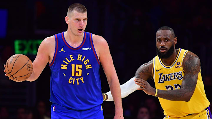 Apr 25, 2024; Los Angeles, California, USA; Denver Nuggets center Nikola Jokic (15) controls the ball against Los Angeles Lakers forward LeBron James (23)  during the second half in game three of the first round for the 2024 NBA playoffs at Crypto.com Arena. 