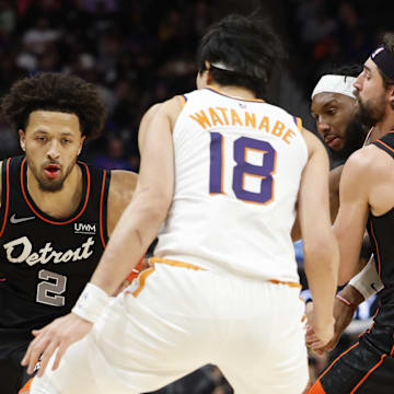 Nov 5, 2023; Detroit, Michigan, USA;  Detroit Pistons guard Cade Cunningham (2) dribbles defended by Phoenix Suns forward Yuta Watanabe (18) in the second half at Little Caesars Arena. Mandatory Credit: Rick Osentoski-Imagn Images