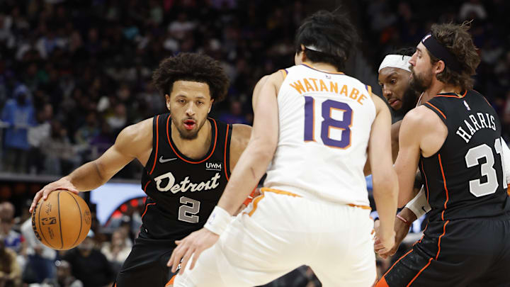 Nov 5, 2023; Detroit, Michigan, USA;  Detroit Pistons guard Cade Cunningham (2) dribbles defended by Phoenix Suns forward Yuta Watanabe (18) in the second half at Little Caesars Arena. Mandatory Credit: Rick Osentoski-Imagn Images