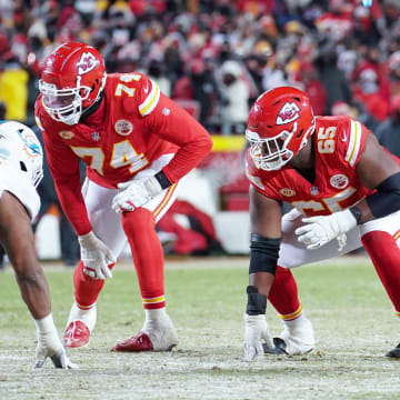 Jan 13, 2024; Kansas City, Missouri, USA; Kansas City Chiefs offensive tackle Jawaan Taylor (74) and guard Trey Smith (65) and center Creed Humphrey (52) at the line of scrimmage against the Miami Dolphins in a 2024 AFC wild card game at GEHA Field at Arrowhead Stadium. Mandatory Credit: Denny Medley-USA TODAY Sports