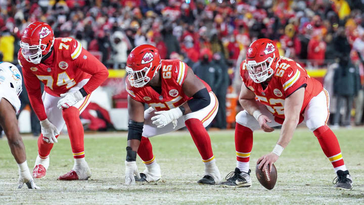 Jan 13, 2024; Kansas City, Missouri, USA; Kansas City Chiefs offensive tackle Jawaan Taylor (74) and guard Trey Smith (65) and center Creed Humphrey (52) at the line of scrimmage against the Miami Dolphins in a 2024 AFC wild card game at GEHA Field at Arrowhead Stadium. Mandatory Credit: Denny Medley-USA TODAY Sports