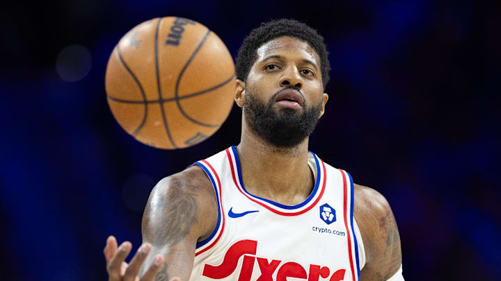 Philadelphia 76ers forward Paul George catches a ball.