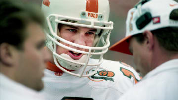 Tennessee freshman quarterback Peyton Manning talks with a coach on the sideline during a break in the action against Vanderbilt. Tennessee shattered one national record, three school records and earned a probable Gator Bowl bid in its 65-0 win over Vanderbilt at Dudley Field in Nashville on Nov. 26, 1994.

94then11 071