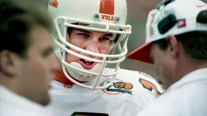 Tennessee freshman quarterback Peyton Manning talks with a coach on the sideline during a break in the action against Vanderbilt. Tennessee shattered one national record, three school records and earned a probable Gator Bowl bid in its 65-0 win over Vanderbilt at Dudley Field in Nashville on Nov. 26, 1994.

94then11 071