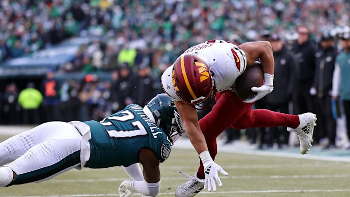 Jan 26, 2025; Philadelphia, PA, USA; Philadelphia Eagles cornerback Quinyon Mitchell (27) tackles Washington Commanders running back Austin Ekeler (30) to stop a two-point conversion during the first half in the NFC Championship game at Lincoln Financial Field. Mandatory Credit: Bill Streicher-Imagn Images