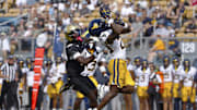 Oct 18, 2025; Orlando, Florida, USA;  West Virginia Mountaineers cornerback Jason Chambers (23) makes an interception on a pass intended for Central Florida Knights wide receiver Waden Charles (19) in the second half at Acrisure Bounce House. Mandatory Credit: Russell Lansford-Imagn Images