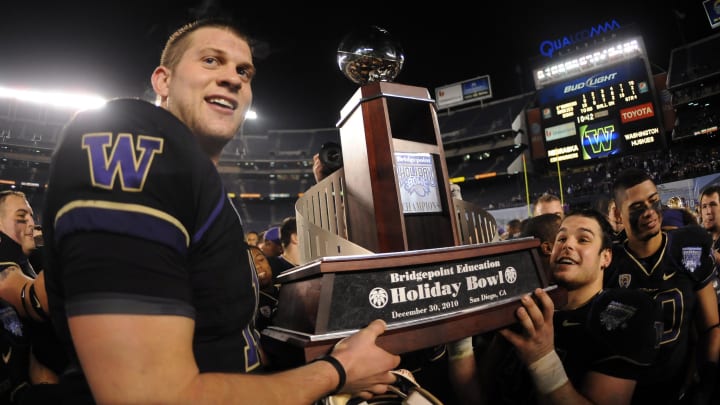 Husky quarterback Jake Locker holds the Holiday Bowl championship trophy following a 19-7 win over the Nebraska Cornhuskers at the 2010 Holiday Bowl.