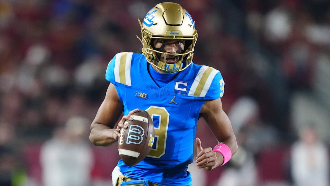 Nov 29, 2025; Los Angeles, California, USA; UCLA Bruins quarterback Nico Iamaleava (9) carries the ball against the Southern California Trojans in the first half at United Airlines Field at Los Angeles Memorial Coliseum. Mandatory Credit: Kirby Lee-Imagn Images