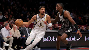 Dec 4, 2024; Brooklyn, New York, USA; Indiana Pacers guard Tyrese Haliburton (0) drives to the basket against Brooklyn Nets guard Shake Milton (7) during the second quarter at Barclays Center. Mandatory Credit: Brad Penner-Imagn Images
