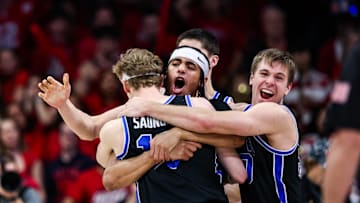 Feb 22, 2025; Tucson, Arizona, USA; BYU Cougars center Keba Keita (13), guard Trey Stewart (1) and guard Dallin Hall (30) celebrate a win against the Arizona Wildcats at the end of the game at McKale Center. Mandatory Credit: Aryanna Frank-Imagn Images