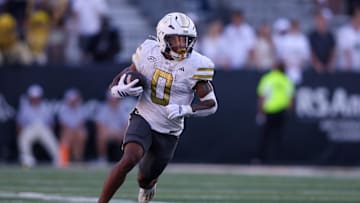 Oct 11, 2025; Atlanta, Georgia, USA; Georgia Tech Yellow Jackets running back Malachi Hosley (0) runs the ball against the Virginia Tech Hokies in the fourth quarter at Bobby Dodd Stadium at Hyundai Field. Mandatory Credit: Brett Davis-Imagn Images
