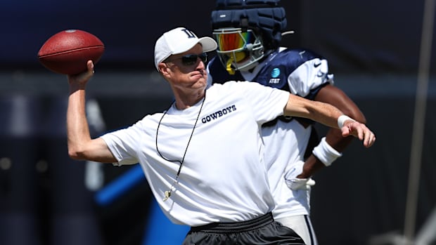 Dallas Cowboys special teams coordinator John Fassel runs a drill during training camp at the River Ridge Playing Fields