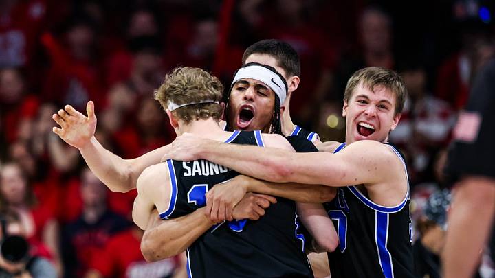 Feb 22, 2025; Tucson, Arizona, USA; BYU Cougars center Keba Keita (13), guard Trey Stewart (1) and guard Dallin Hall (30) celebrate a win against the Arizona Wildcats at the end of the game at McKale Center. Mandatory Credit: Aryanna Frank-Imagn Images