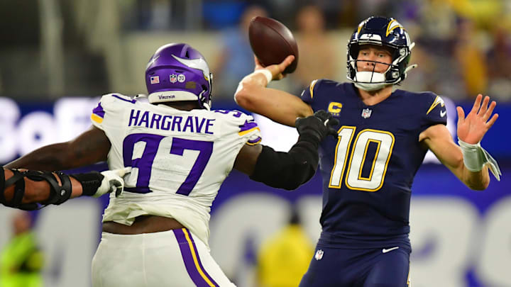 Oct 23, 2025; Inglewood, California, USA; Minnesota Vikings defensive tackle Javon Hargrave (97) gets pressure on Los Angeles Chargers quarterback Justin Herbert (10) during the first half at SoFi Stadium. Mandatory Credit: Gary A. Vasquez-Imagn Images