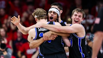 Feb 22, 2025; Tucson, Arizona, USA; BYU Cougars center Keba Keita (13), guard Trey Stewart (1) and guard Dallin Hall (30) celebrate a win against the Arizona Wildcats at the end of the game at McKale Center. Mandatory Credit: Aryanna Frank-Imagn Images