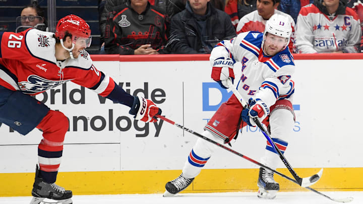 Dec 31, 2025; Washington, District of Columbia, USA; New York Rangers left wing Conor Sheary (43) passes the puck defended by Washington Capitals center Nic Dowd (26) during the first period at Capital One Arena. Mandatory Credit: Hannah Foslien-Imagn Images