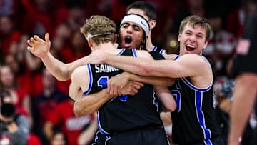 Feb 22, 2025; Tucson, Arizona, USA; BYU Cougars center Keba Keita (13), guard Trey Stewart (1) and guard Dallin Hall (30) celebrate a win against the Arizona Wildcats at the end of the game at McKale Center. Mandatory Credit: Aryanna Frank-Imagn Images