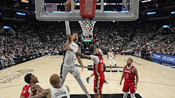 Dec 17, 2023; San Antonio, Texas, USA; San Antonio Spurs forward Victor Wembanyama (1) dunks over New Orleans Pelicans Brandon Ingram (14) during the first half at Frost Bank Center.