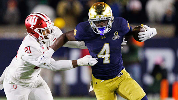Notre Dame running back Jeremiyah Love runs the ball past Indiana linebacker Rolijah Hardy in the College Football Playoff