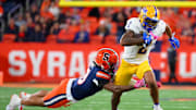 Oct 18, 2025; Syracuse, New York, USA; /Pittsburgh Panthers wide receiver Kenny Johnson (2) runs with the ball as Syracuse Orange defensive back Davien Kerr (10) makes a diving tackle attempt during the first half at the JMA Wireless Dome. Mandatory Credit: Rich Barnes-Imagn Images