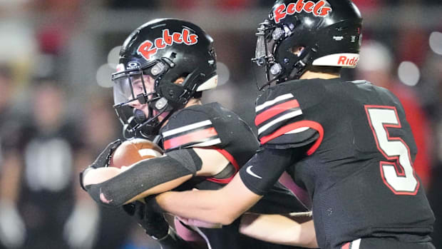 Maryville's Will Jones (5) hands off to Price Davis (1) during a TSSAA high school football game on Friday, Oct. 25, 2024, in