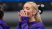 LSU gymnast Livvy Dunne stretches with teammates before Session 2 of the SEC Gymnastics Tournament.