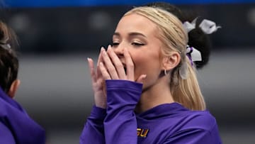 LSU gymnast Livvy Dunne stretches with teammates before Session 2 of the SEC Gymnastics Tournament.