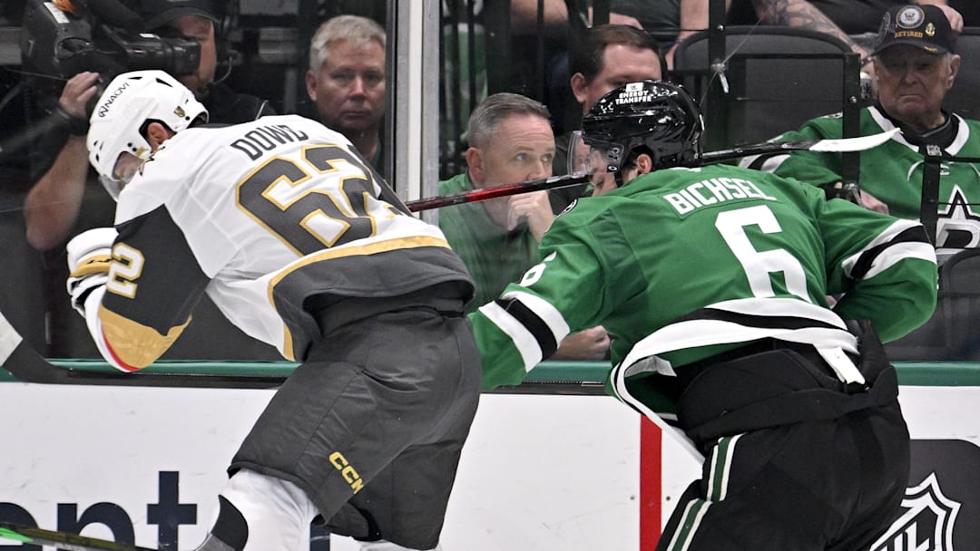 Mar 10, 2026; Dallas, Texas, USA; Vegas Golden Knights center Nic Dowd (62) is called for a high stick on Dallas Stars defenseman Lian Bichsel (6) during the second period at the American Airlines Center. Mandatory Credit: Jerome Miron-Imagn Images