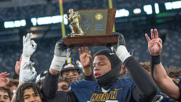 North’s Ja’Elyne Matthews holds up the trophy. Toms River North dominates Union City 41-14