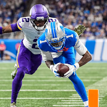Detroit Lions wide receiver Jameson Williams (1) dives for a touchdown against Minnesota Vikings cornerback Isaiah Rodgers (2) during the second half at Ford Field in Detroit on Sunday, November 2, 2025.