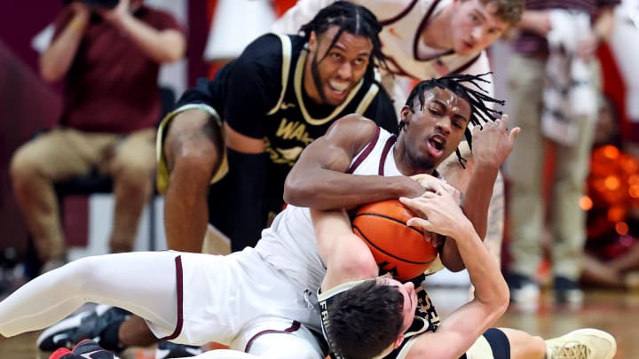 Mar 2, 2024; Blacksburg, Virginia, USA; Virginia Tech Hokies guard MJ Collins (2) and Wake Forest Demon Deacons guard Parker Friedrichsen (20) go for a loose ball during the first half at Cassell Coliseum. Mandatory Credit: Peter Casey-USA TODAY Sports