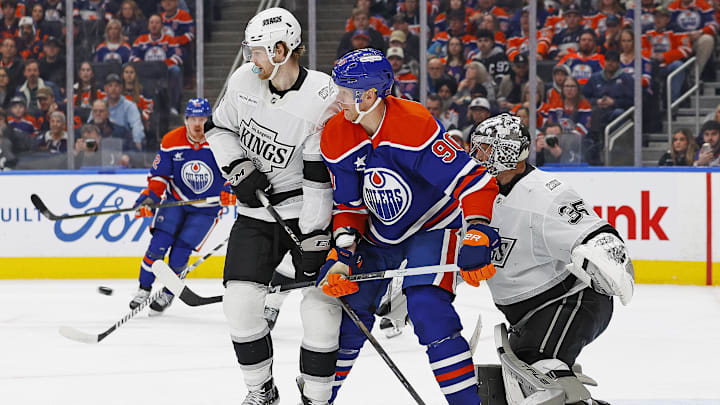 Jan 13, 2025; Edmonton, Alberta, CAN; Edmonton Oilers forward Corey Perry (90) battles with Los Angeles Kings forward Warren Foegele (37) in front of Los Angeles Kings goaltender Darcy Kuemper (35) during the third period at Rogers Place. Mandatory Credit: Perry Nelson-Imagn Images