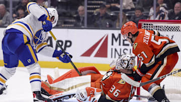 Nov 22, 2024; Anaheim, California, USA; Buffalo Sabres defenseman Bowen Byram (4) shoots against Anaheim Ducks goaltender John Gibson (36) and defenseman Olen Zellweger (51) during the third period at Honda Center. Mandatory Credit: Ryan Sun-Imagn Images