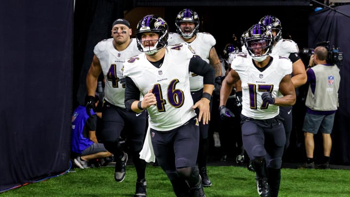 Nov 7, 2022; New Orleans, Louisiana, USA;  Baltimore Ravens long snapper Nick Moore (46) and running back Kenyan Drake (17) run out the tunnel against the New Orleans Saints during the warm ups at Caesars Superdome. Mandatory Credit: Stephen Lew-USA TODAY Sports