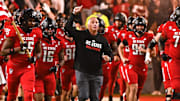 Nov 4, 2023; Raleigh, North Carolina, USA; North Carolina State Wolfpack head coach Dave Doeren (center) lead his team onto the field prior to a game against the Miami Hurricanes at Carter-Finley Stadium. Mandatory Credit: Rob Kinnan-Imagn Images