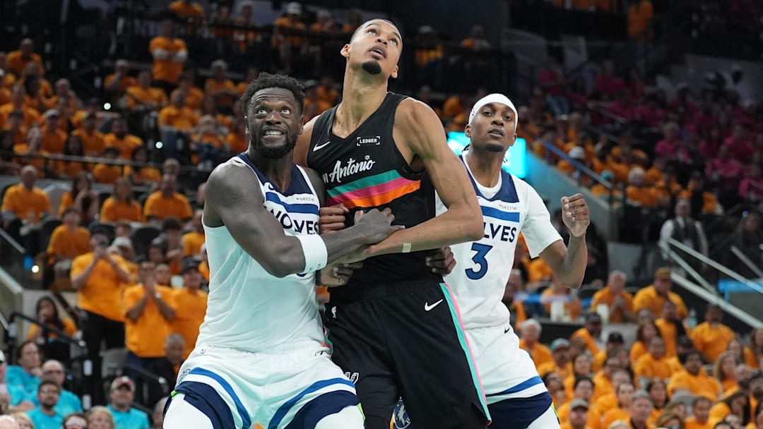 May 4, 2026; San Antonio, Texas, USA; Minnesota Timberwolves forwards Julius Randle (30) and Jaden McDaniels (3) try to keep San Antonio Spurs forward Victor Wembanyama (1) back in the second half during game one of the second round of the 2026 NBA Playoffs at Frost Bank Center.