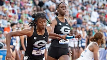 Georgia’s Dejanea Oakley, right, hands off the baton to Michelle Smith in the women’s 4x400-meter relay on the final day of the NCAA Outdoor Track and Field Championships on June 14, 2025, at Hayward Field in Eugene.