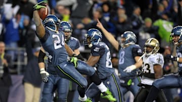 Jan 8, 2011; Seattle, WA, USA; Seattle Seahawks running back Marshawn Lynch (24) leaps into the end zone to score on a 67-yard touchdown run in the fourth quarter of the NFC Wild Card playoff game against the New Orleans Saints at Qwest Field. Mandatory Credit: Kirby Lee/Image of Sport-Imagn Images