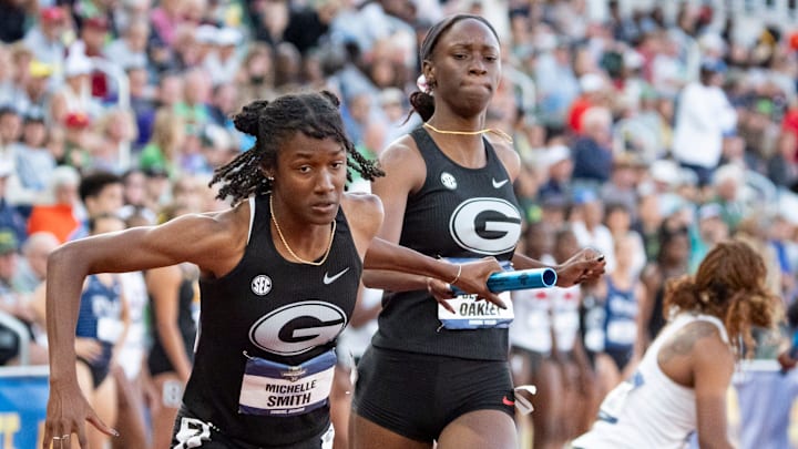Georgia’s Dejanea Oakley, right, hands off the baton to Michelle Smith in the women’s 4x400-meter relay on the final day of the NCAA Outdoor Track and Field Championships on June 14, 2025, at Hayward Field in Eugene.