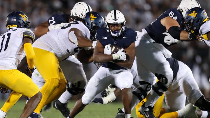 Penn State running back Nicholas Singleton carries the ball against the West Virginia Mountaineers during the fourth quarter at Beaver Stadium in 2023. 