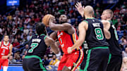Mar 30, 2024; New Orleans, Louisiana, USA; New Orleans Pelicans forward Zion Williamson (1) shoots the ball over Boston Celtics guard Jaylen Brown (7) and guard Derrick White (9) and center Kristaps Porzingis (8) during the second half at Smoothie King Center. Mandatory Credit: Stephen Lew-Imagn Images