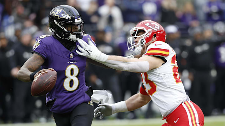 Jan 28, 2024; Baltimore, Maryland, USA; Baltimore Ravens quarterback Lamar Jackson (8) prepares to throw the ball as Kansas City Chiefs linebacker Drue Tranquill (23) defends during the first half in the AFC Championship football game at M&T Bank Stadium. Mandatory Credit: Geoff Burke-Imagn Images