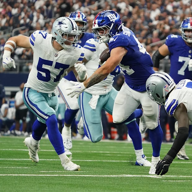 New York Giants running back Cam Skattebo runs with the ball as Dallas Cowboys linebacker Jack Sanborn and safety Donovan Wil