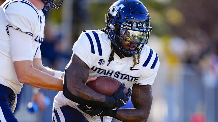 Oct 26, 2024; Laramie, Wyoming, USA; Utah State Aggies running back Rahsul Faison (3) warms up before the game against the Wyoming Cowboys at Jonah Field at War Memorial Stadium. Mandatory Credit: Troy Babbitt-Imagn Images
