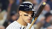 Oct 7, 2025; Bronx, New York, USA; New York Yankees outfielder Aaron Judge (99) flips his bat after hitting a three-run home run in the fourth inning against the Toronto Blue Jays during game three of the ALDS round for the 2025 MLB playoffs at Yankee Stadium. Mandatory Credit: Wendell Cruz-Imagn Images
