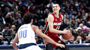 Feb 13, 2025; Dallas, Texas, USA; Miami Heat guard Tyler Herro (14) controls the ball as Dallas Mavericks guard Max Christie (00) defends during the second half at American Airlines Center. Mandatory Credit: Kevin Jairaj-Imagn Images