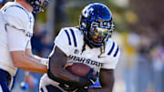 Oct 26, 2024; Laramie, Wyoming, USA; Utah State Aggies running back Rahsul Faison (3) warms up before the game against the Wyoming Cowboys at Jonah Field at War Memorial Stadium. Mandatory Credit: Troy Babbitt-Imagn Images